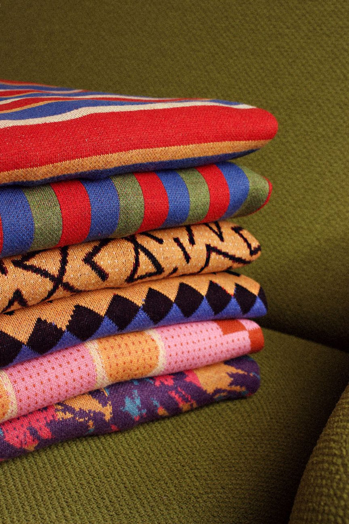 A pile of custom knit sweaters  Made by Knitwise KOD platform