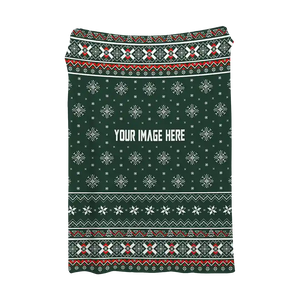 Green Christmas blanket with white and red snowflakes and ribbons