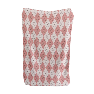 Soft pink and white argyle blanket for a cozy, pastel-inspired interior